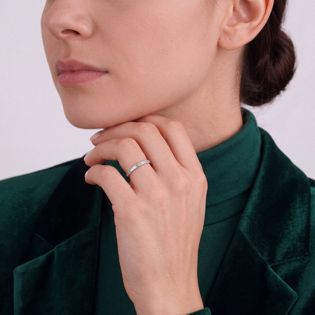 Woman in an emerald velvet blazer wearing a 0.51 ct tw natural diamond baguette half eternity ring in 14K white gold