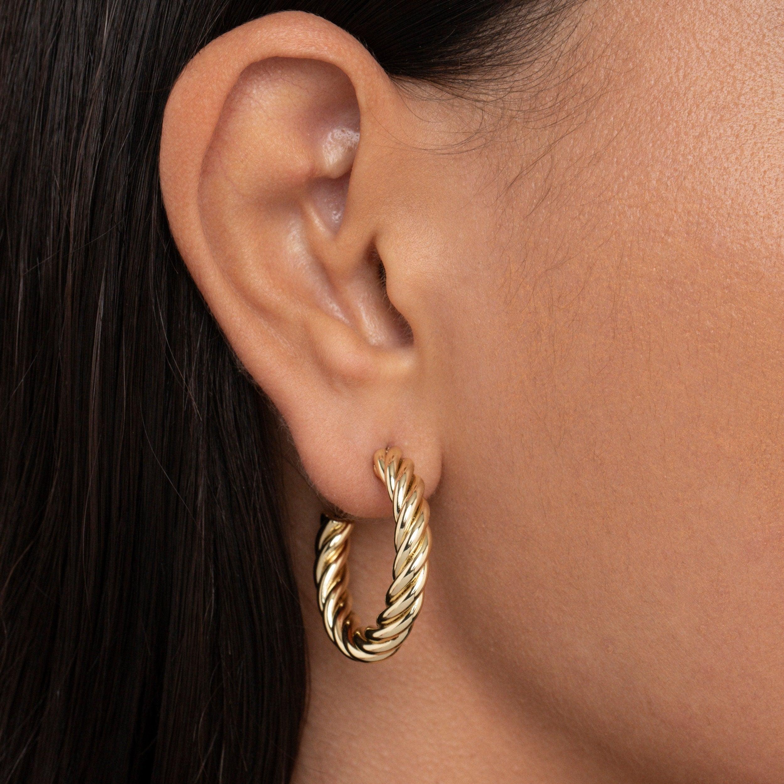 Close detail of the Twisted Hoop Earrings in Gold-Plated Steel. Tarnish-resistant, premium handmade jewelry.