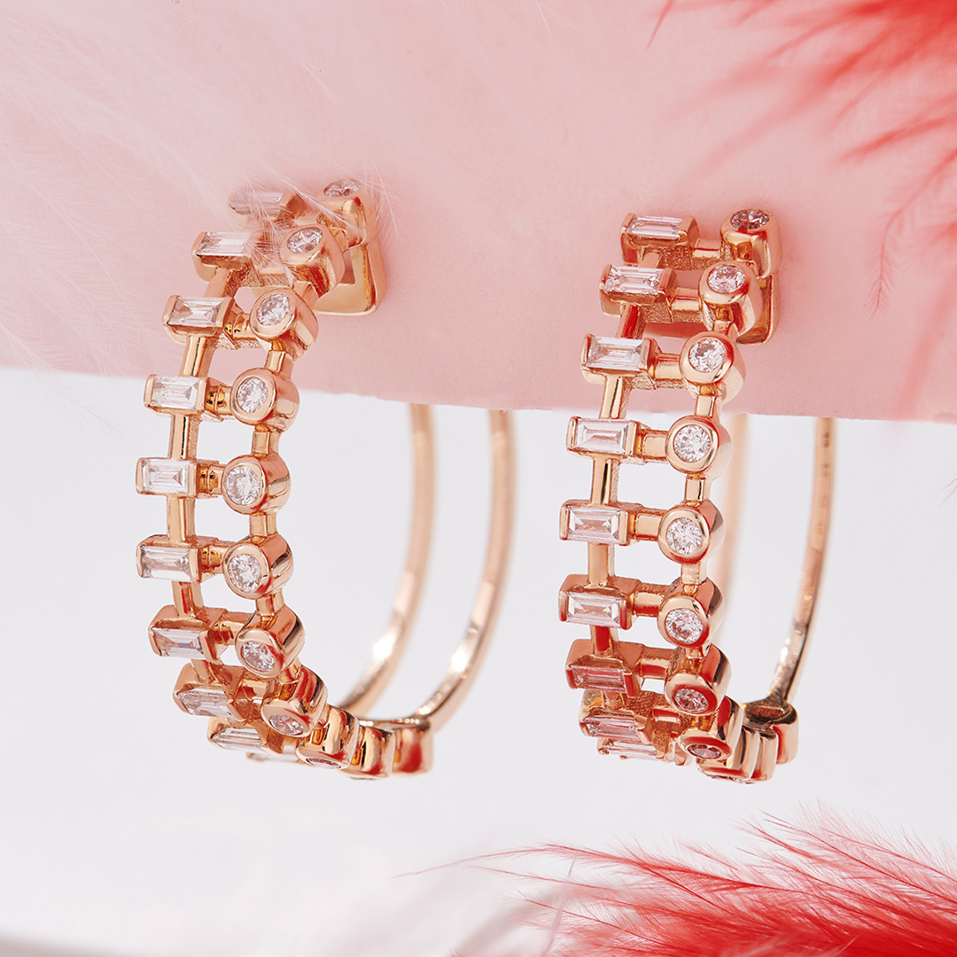 Baguette and round natural diamond ladder hoop earrings in 14K rose gold at an angle, showing the open double-wire back