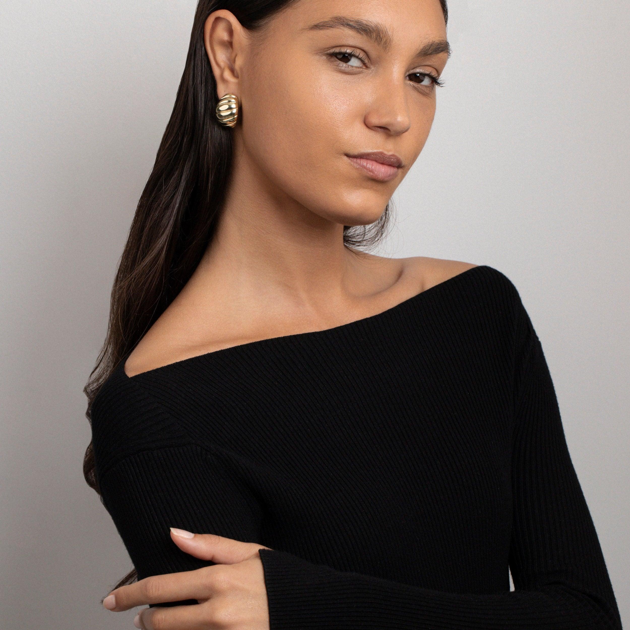 Close detail of the Chunky Croissant Dome Earrings in Gold-Plated Steel. Tarnish-resistant, premium handmade jewelry.