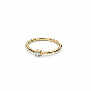 Gold ring with a small diamond on a white background
