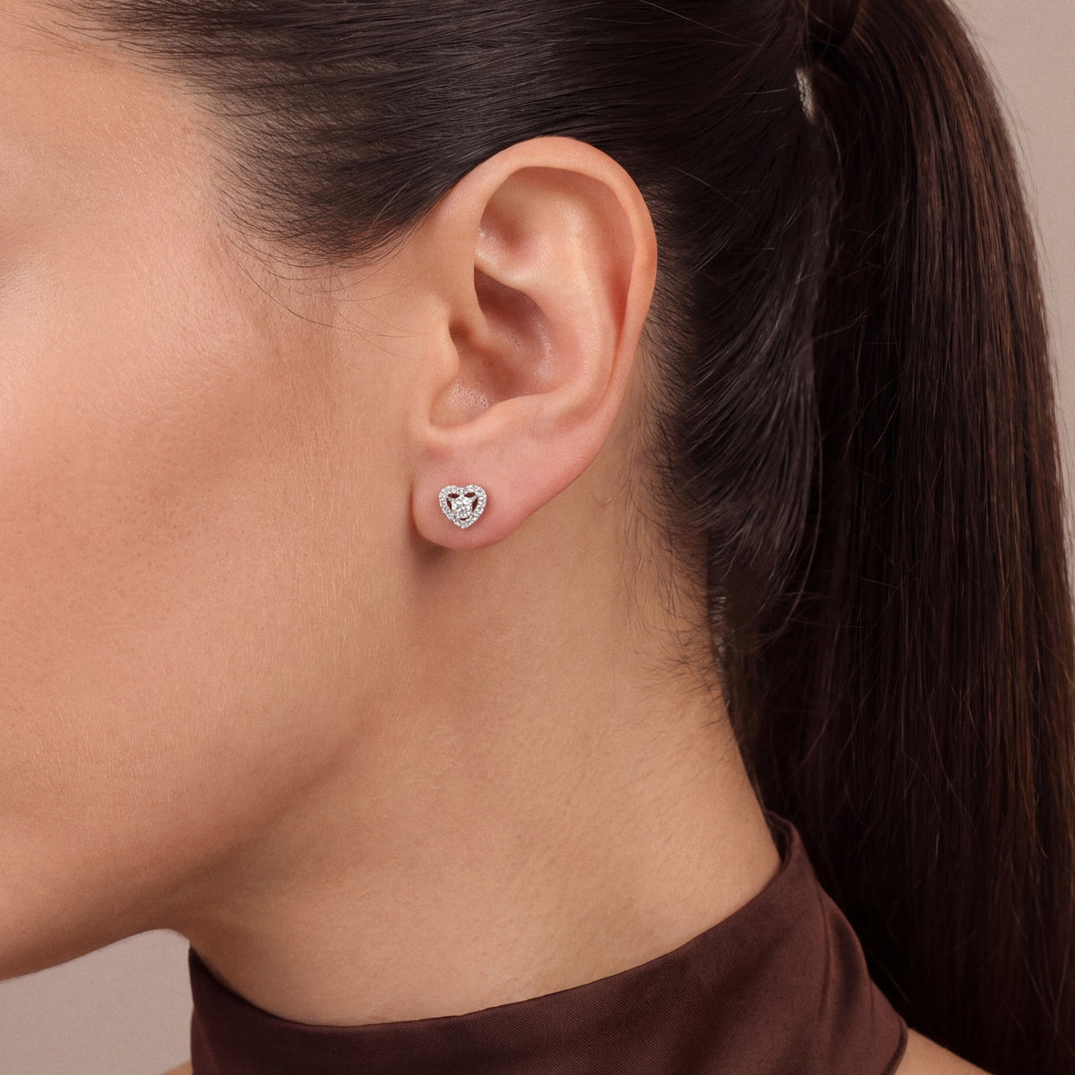 0.36 ct natural diamond heart stud in 18K white gold, worn with a chocolate satin high-neck halter