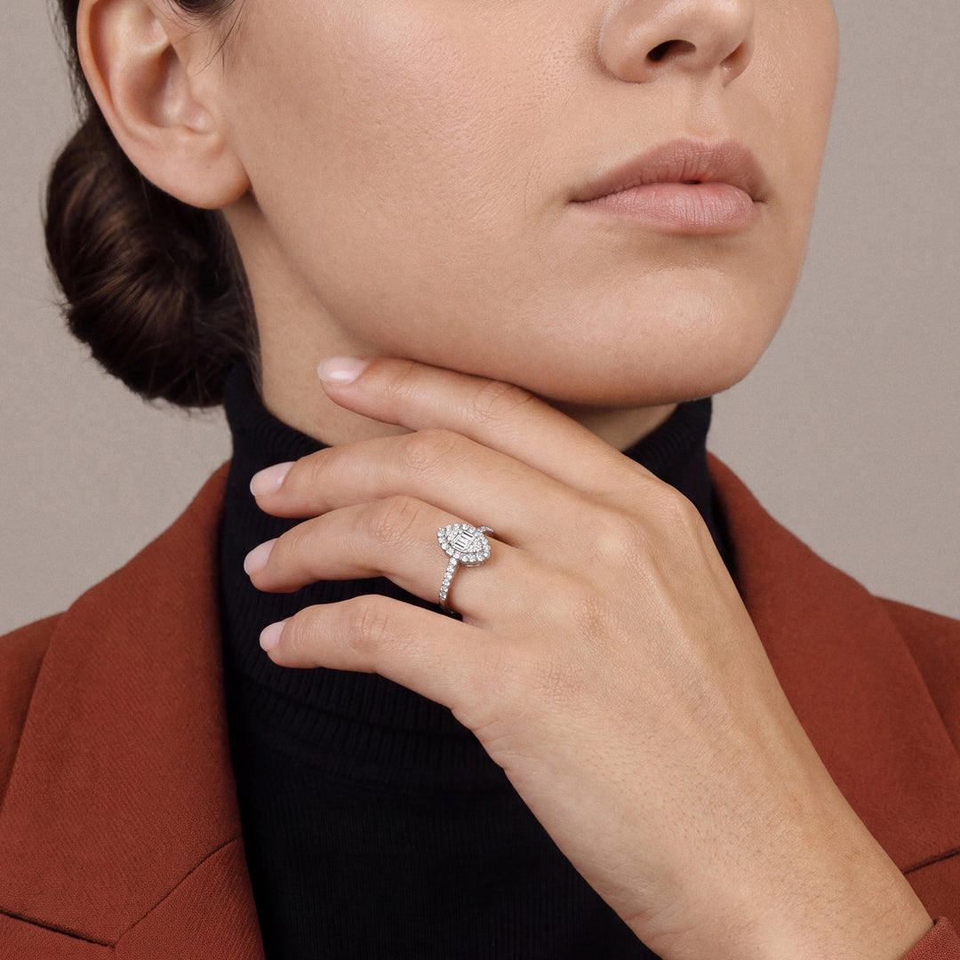 Woman in a rust blazer over a black turtleneck wearing a 0.48 ct tw natural diamond marquise-shaped baguette halo ring in 14K white gold