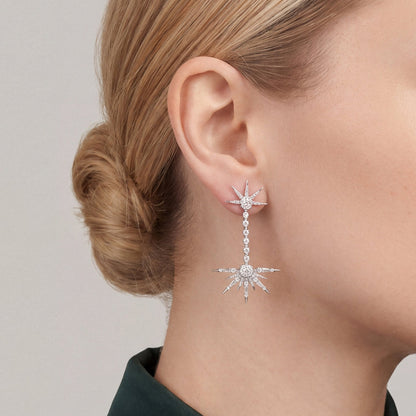 Woman in a bottle-green satin shirt wearing a 1.24 ct tw natural diamond starburst drop earring in 18K white gold