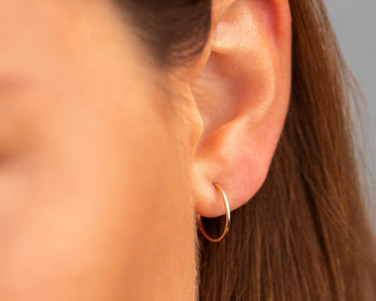 The 14K Solid Gold Endless Hoop Earrings styled — elegant everyday jewelry. Solid gold luxury.