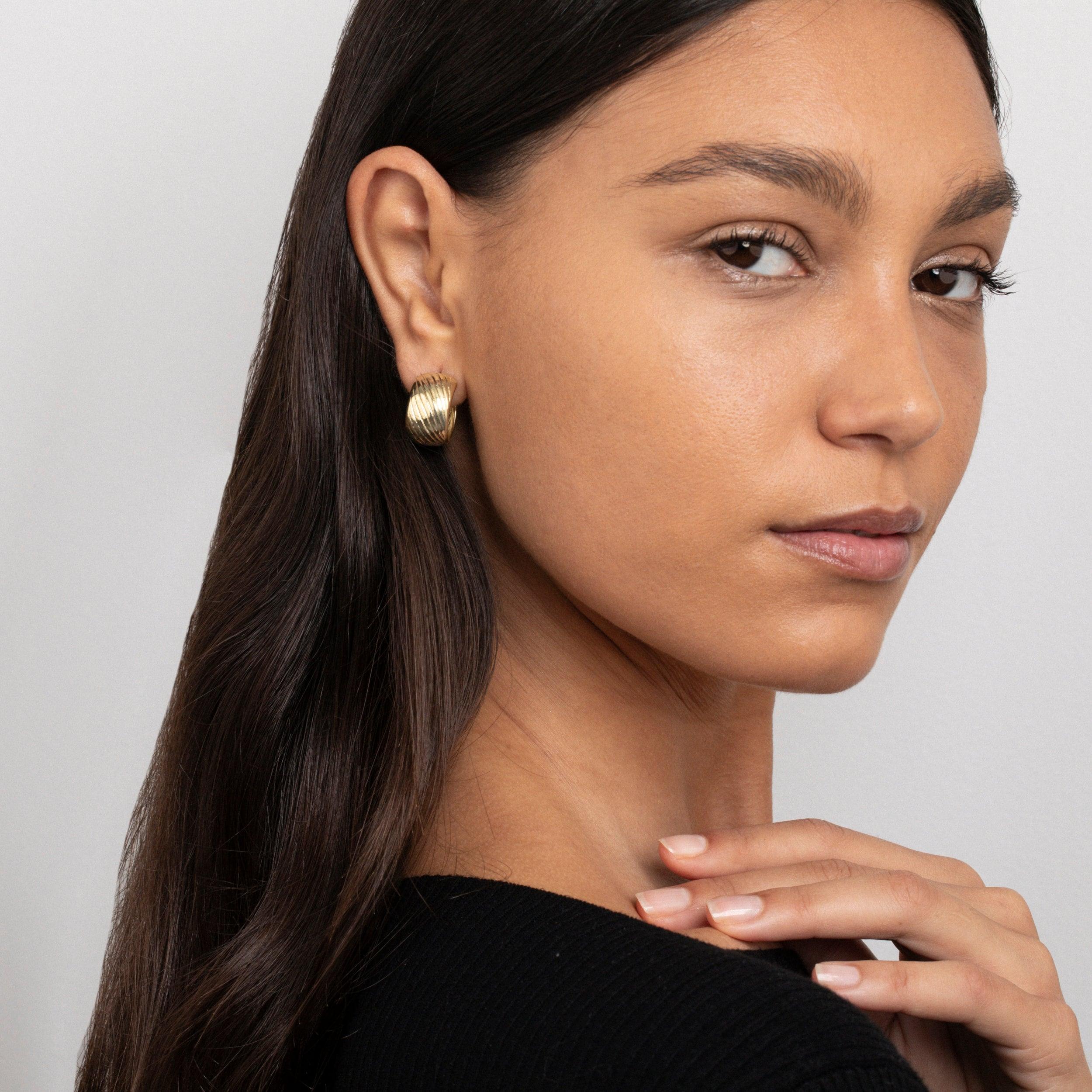The Chunky Textured Hoop Earrings styled in Gold-Plated Steel — elegant everyday jewelry. Hypoallergenic for sensitive ears.