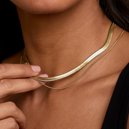Close detail of the Layered Herringbone and Snake Necklace in Gold-Plated Steel. Hypoallergenic, no green marks, premium.