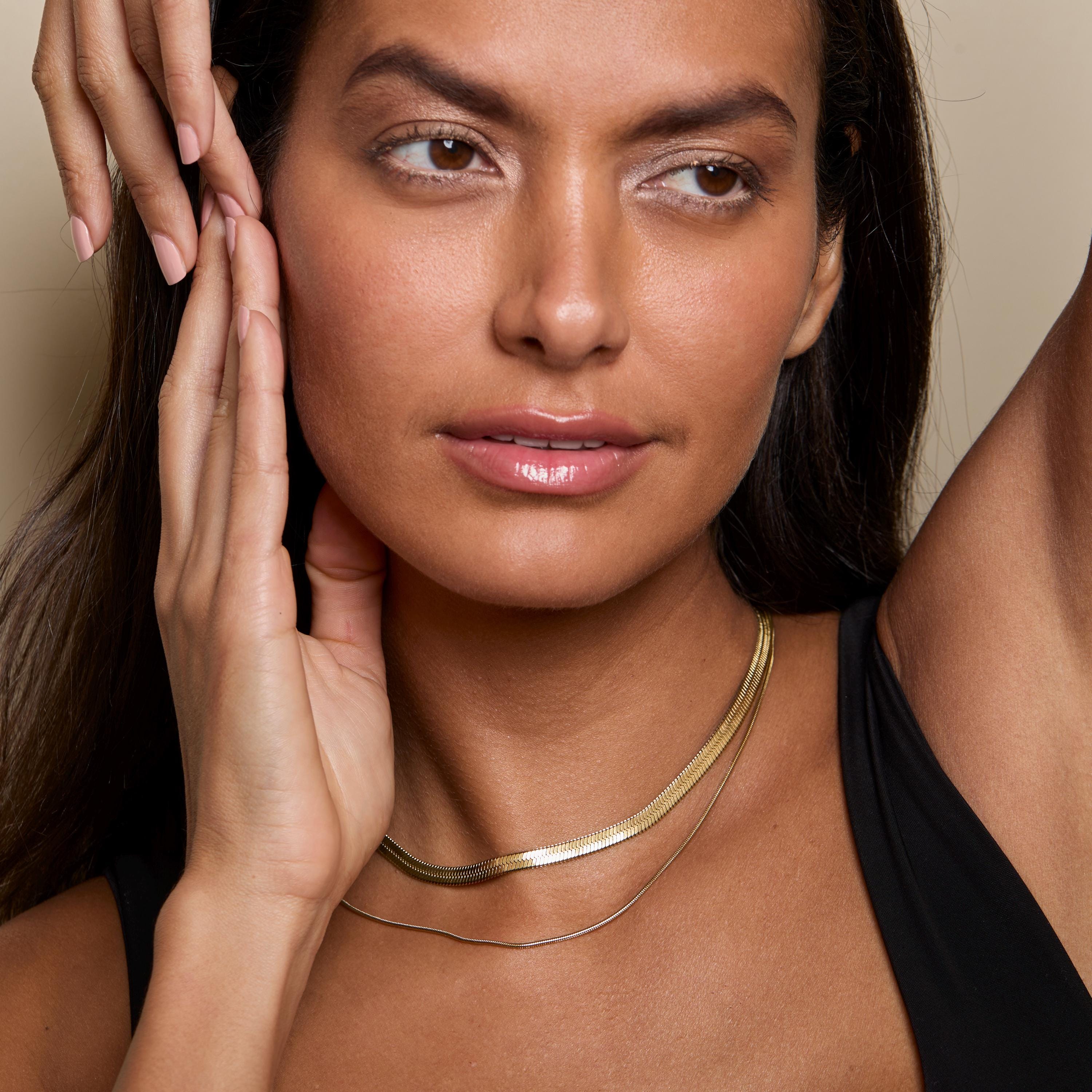 The Layered Herringbone and Snake Necklace styled in Gold-Plated Steel — elegant everyday jewelry. Tarnish-resistant.