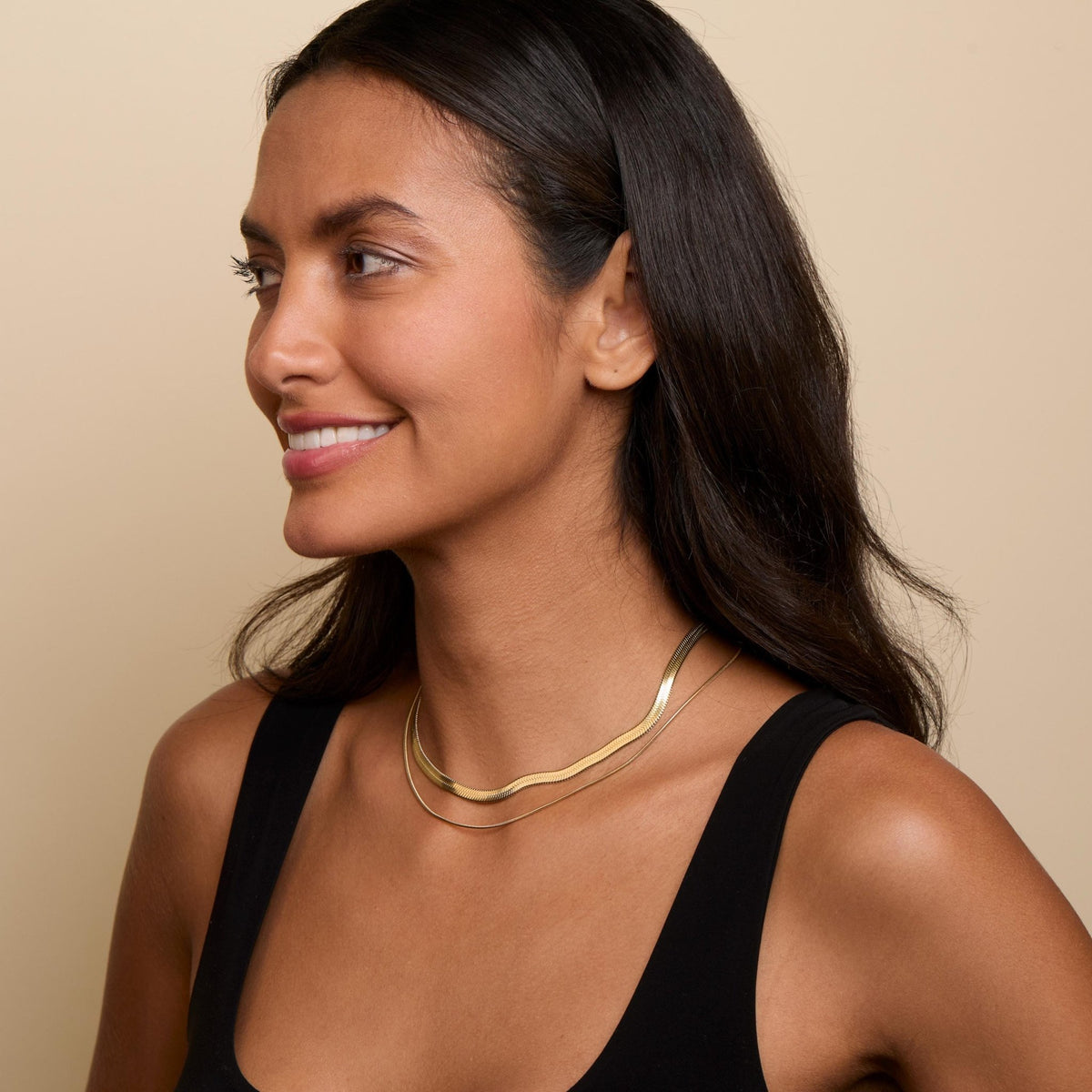 The Layered Herringbone and Snake Necklace as an anniversary gift in Gold-Plated Steel. Tarnish-resistant, made for keeping.