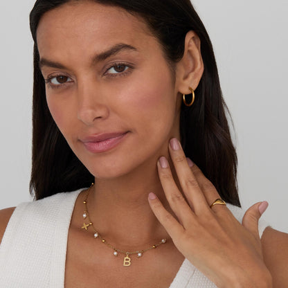 The Initial Necklace with Pearls styled in Gold-Plated Steel — elegant everyday jewelry. Hypoallergenic, no green marks.