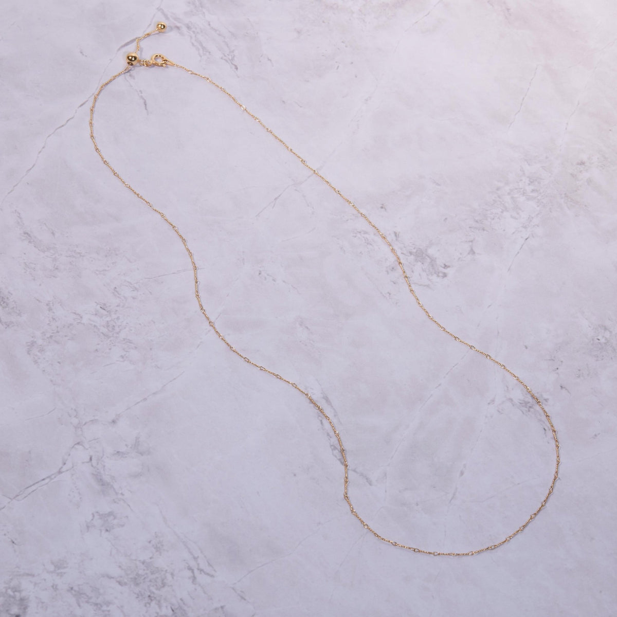Macro detail of the Gold Dainty Twist Layering Chain showcasing craftsmanship in 18K Gold Vermeil. Tarnish-resistant.