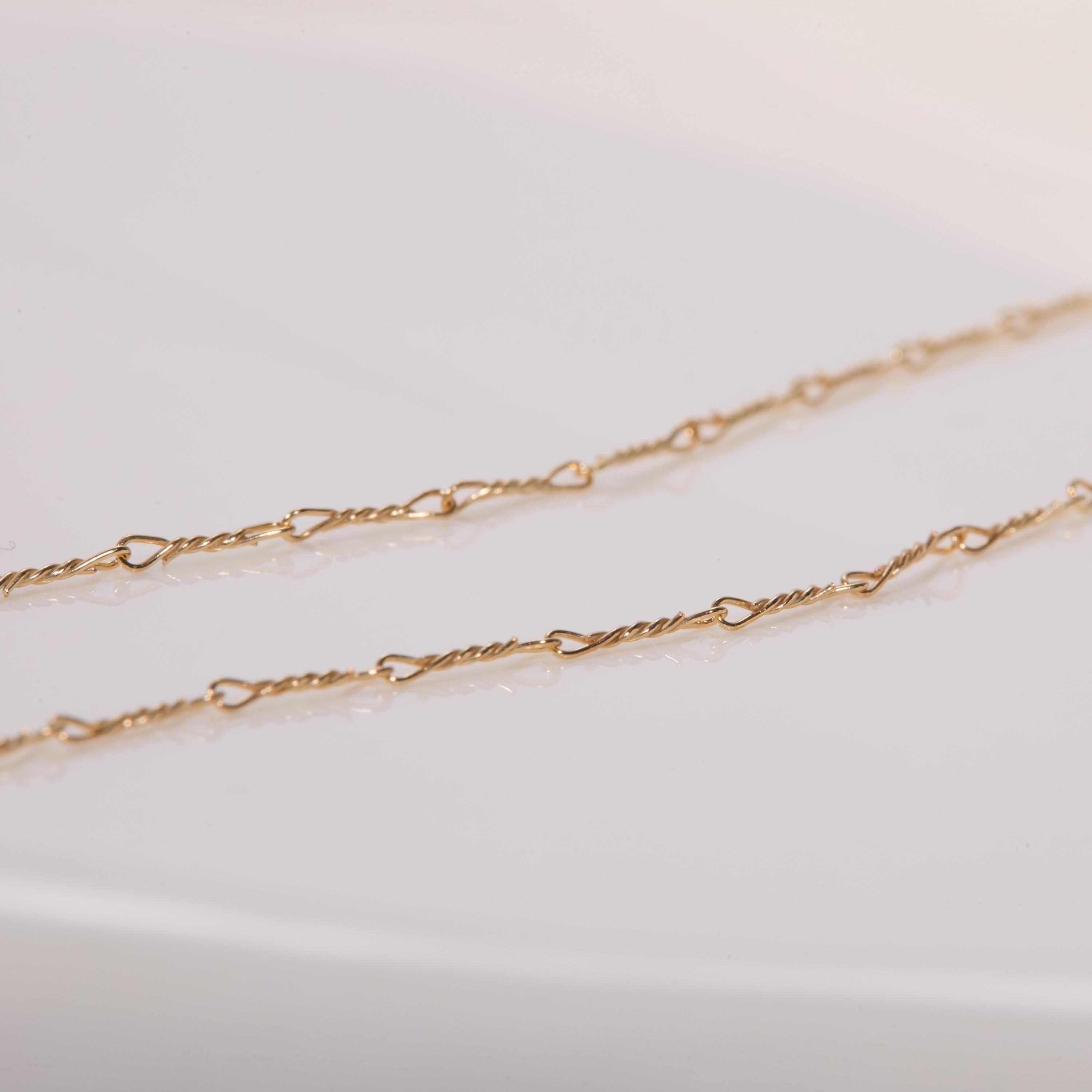 The Gold Dainty Twist Layering Chain worn in 18K Gold Vermeil — refined accessory for women. Hypoallergenic, no green marks.