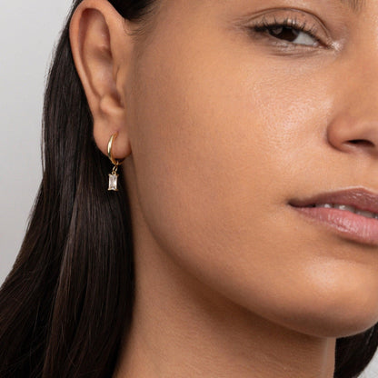 The Dangling Baguette CZ Diamond Hoop Earrings styled in Gold-Plated Steel — elegant everyday jewelry. Hypoallergenic.