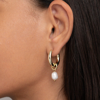 Close detail of the Chunky Pearl Hoop Earrings in Gold-Plated Steel with Freshwater Pearl. Tarnish-resistant, premium.