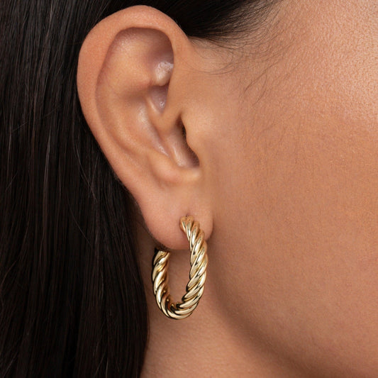 Close detail of the Twisted Hoop Earrings in Gold-Plated Steel. Tarnish-resistant, premium handmade jewelry.
