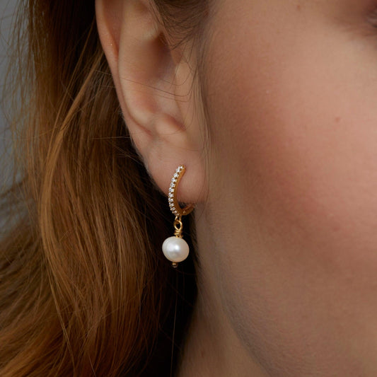 Close detail of the Pavé Pearl Hoop Earrings in 18K Gold Vermeil with Freshwater Pearl and CZ Diamond. Tarnish-resistant.