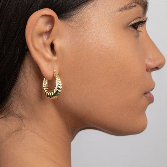 Close detail of the Shrimp Shell Hoop Earrings in Gold-Plated Steel. Tarnish-resistant, premium handmade jewelry.