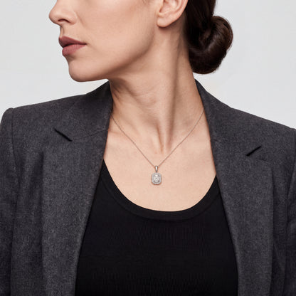 Model wearing the Art Deco baguette natural diamond halo necklace in 14K solid white gold with a charcoal blazer over a black top