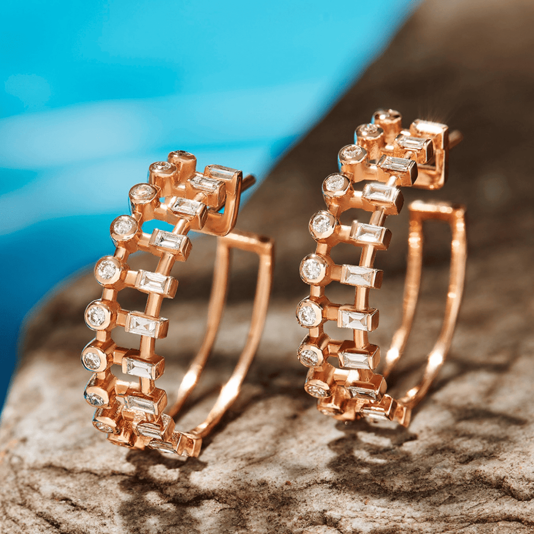 Baguette and round natural diamond hoop earrings in 14K rose gold at an angle, showing the open double-wire back