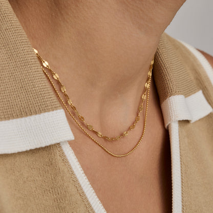 Close view of the Ball Chain Necklace layered with a flat gold chain.