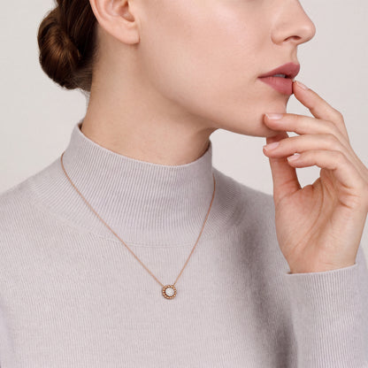 Model in a dove-grey cashmere high-neck top wearing a 0.13 ct natural diamond pavé disc pendant necklace in 14K rose and white gold