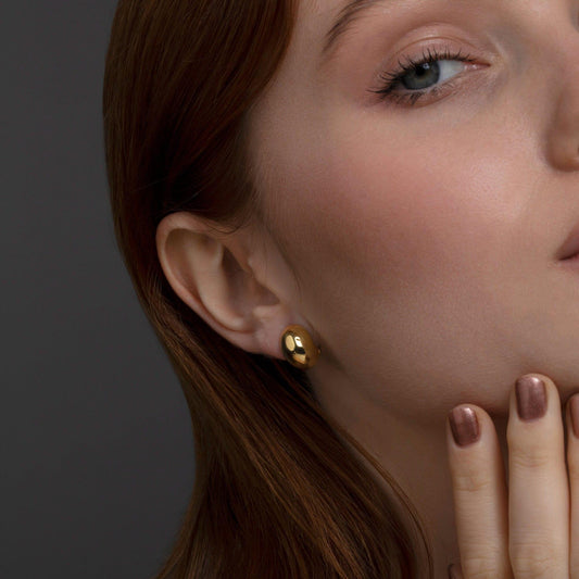 Close detail of the Bold Hinged Huggie Hoop Earrings in 18K Gold Vermeil. Tarnish-resistant, premium handmade jewelry.