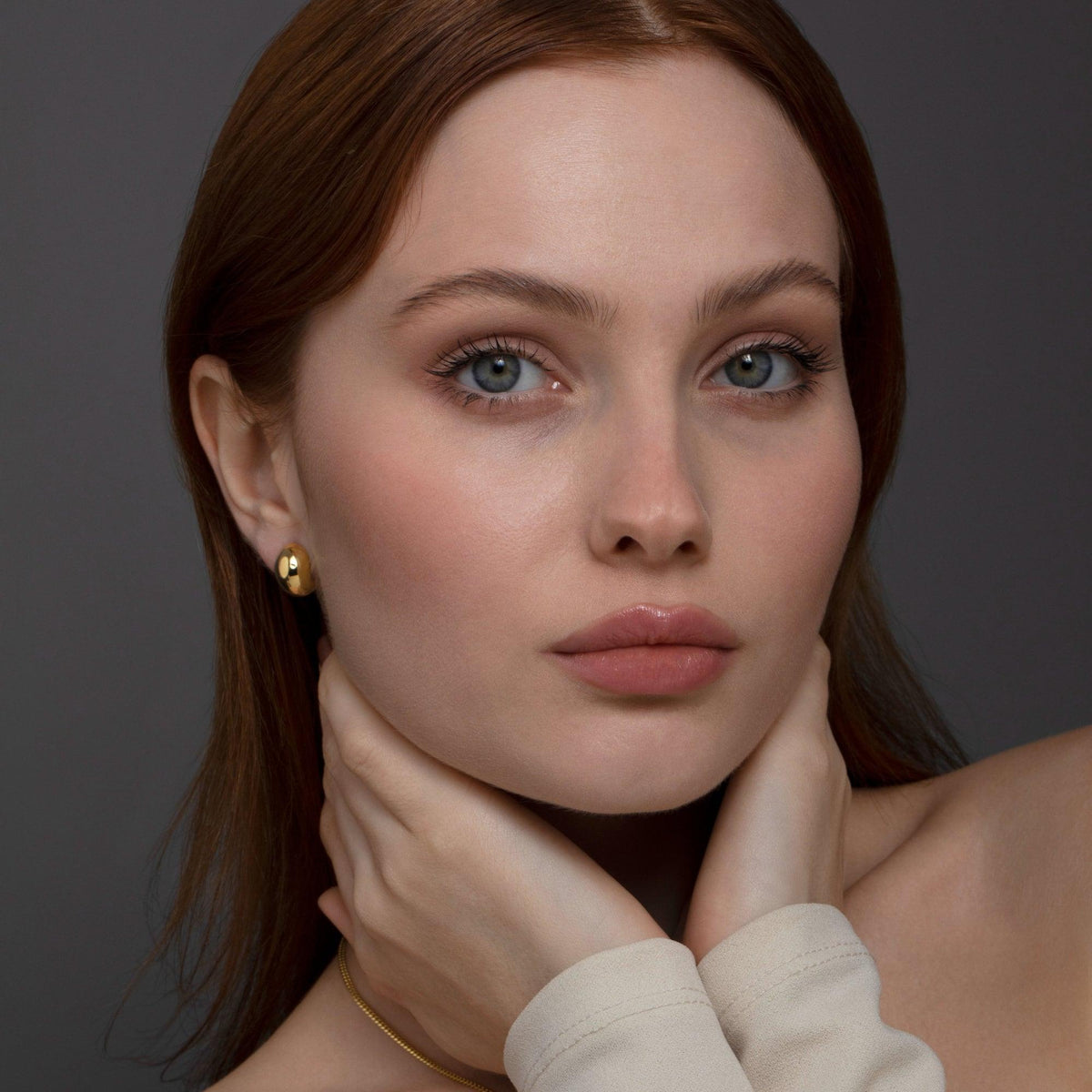 The Bold Hinged Huggie Hoop Earrings styled in 18K Gold Vermeil — elegant everyday jewelry. Hypoallergenic for sensitive.