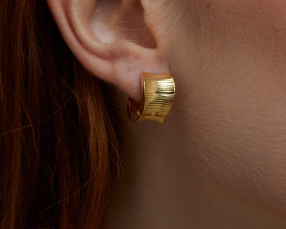 Macro detail of the Bold Huggie Hoop Earring showcasing craftsmanship in 18K Gold Vermeil. No green marks, handmade.