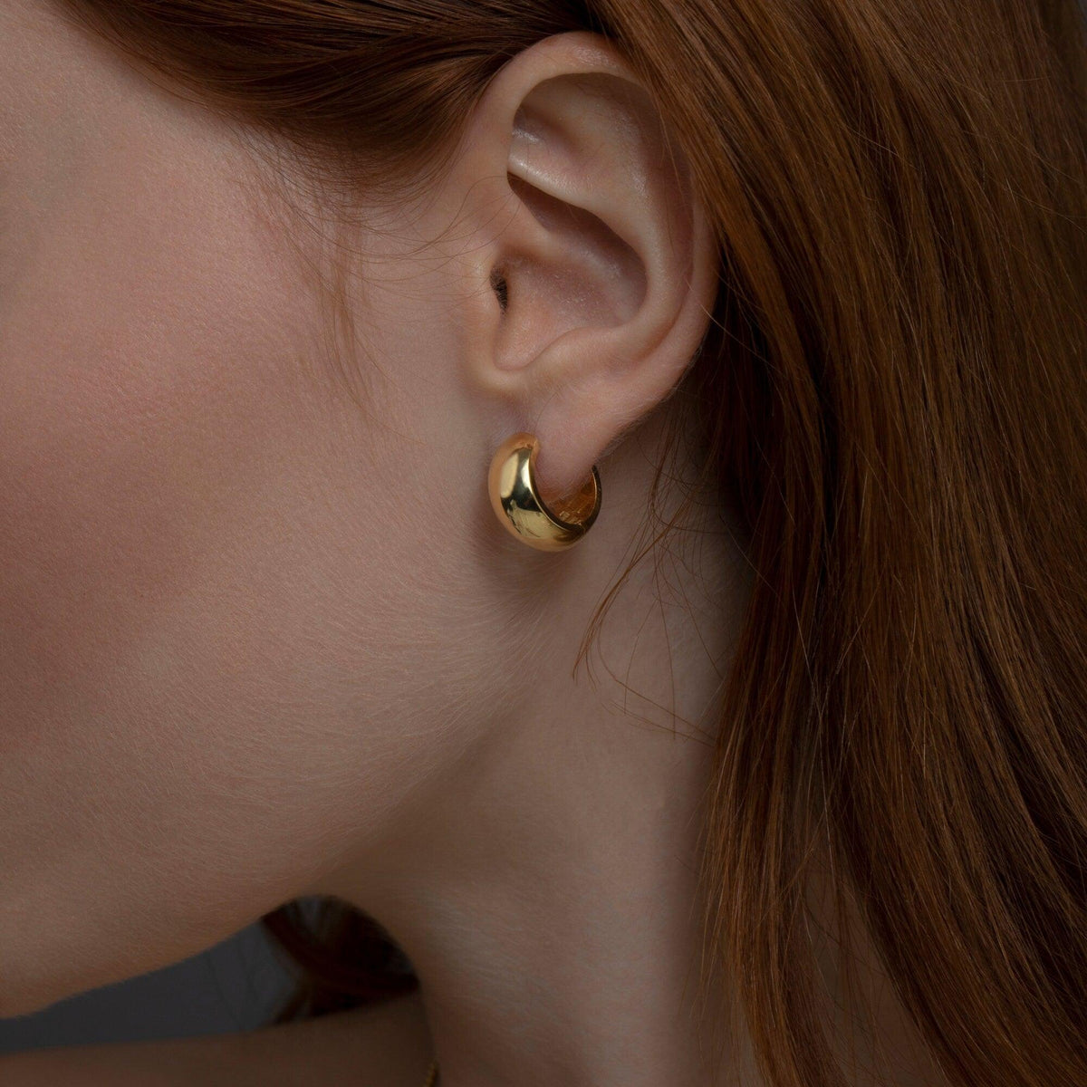 The Bold Hinged Huggie Earrings styled in 18K Gold Vermeil — elegant everyday jewelry. Hypoallergenic for sensitive ears.