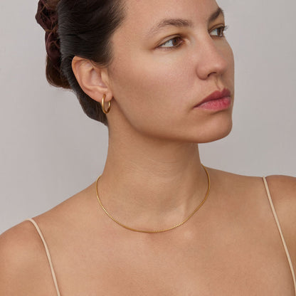 Woman wearing the 1.3 mm Box Chain Necklace in gold — dainty everyday chain.