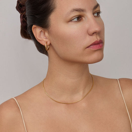 Woman wearing the 1.3 mm Box Chain Necklace in gold — dainty everyday chain.