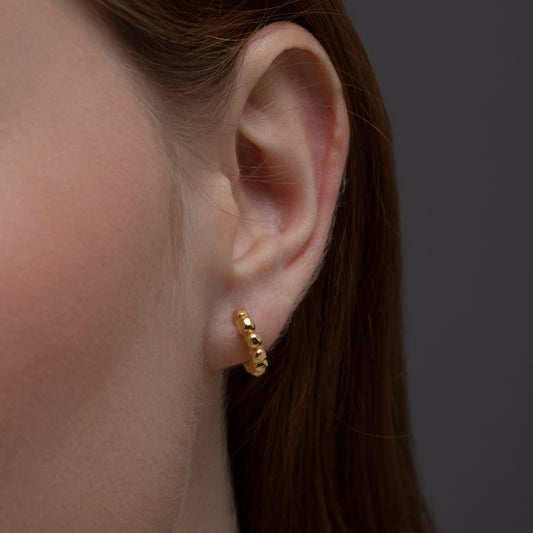 Close detail of the Bubble Ball Huggie Hoop Earring in 18K Gold Vermeil. Tarnish-resistant, premium handmade jewelry.