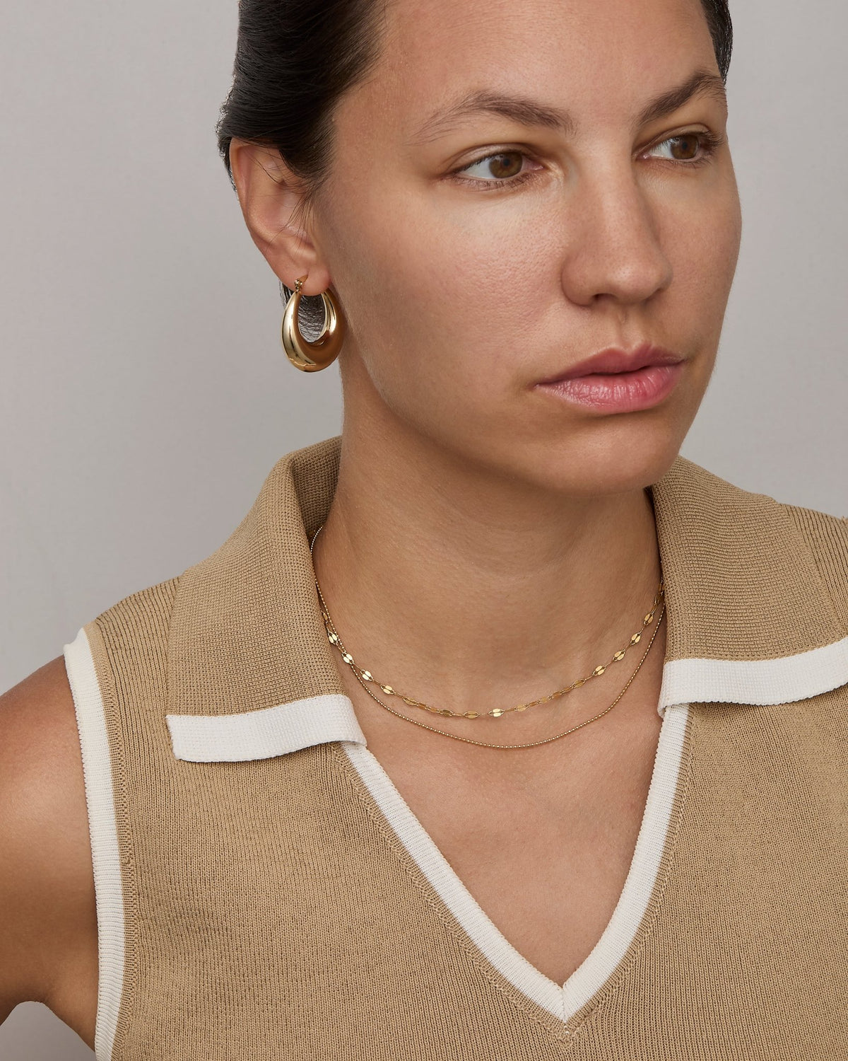 Gold buc chain necklace at collarbone length