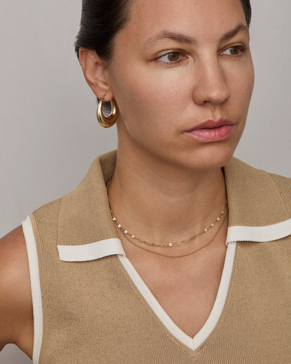 Gold buc chain necklace at collarbone length