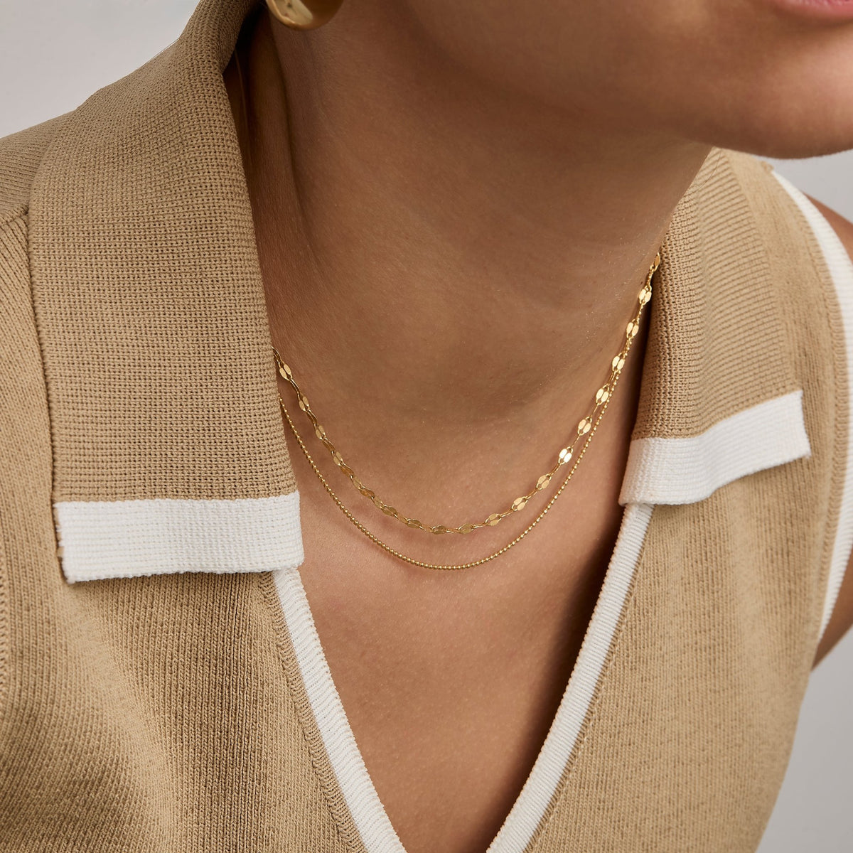 Gold buc chain necklace worn on the neck