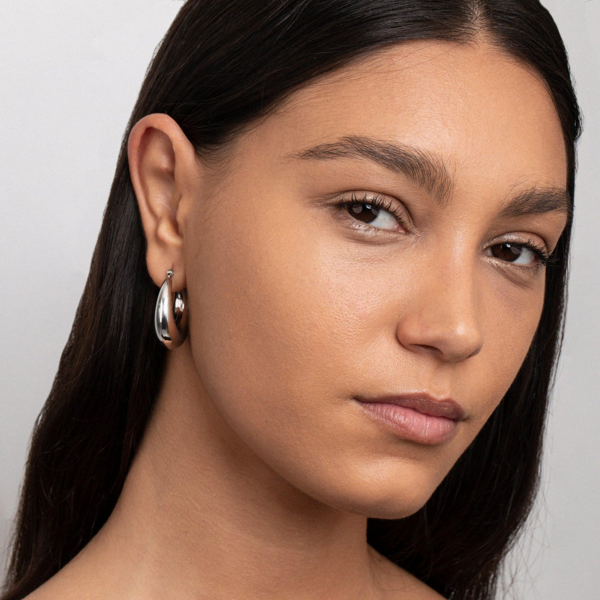 The Chunky Silver Hoops styled in Stainless Steel — elegant everyday jewelry. Never tarnishes, waterproof.
