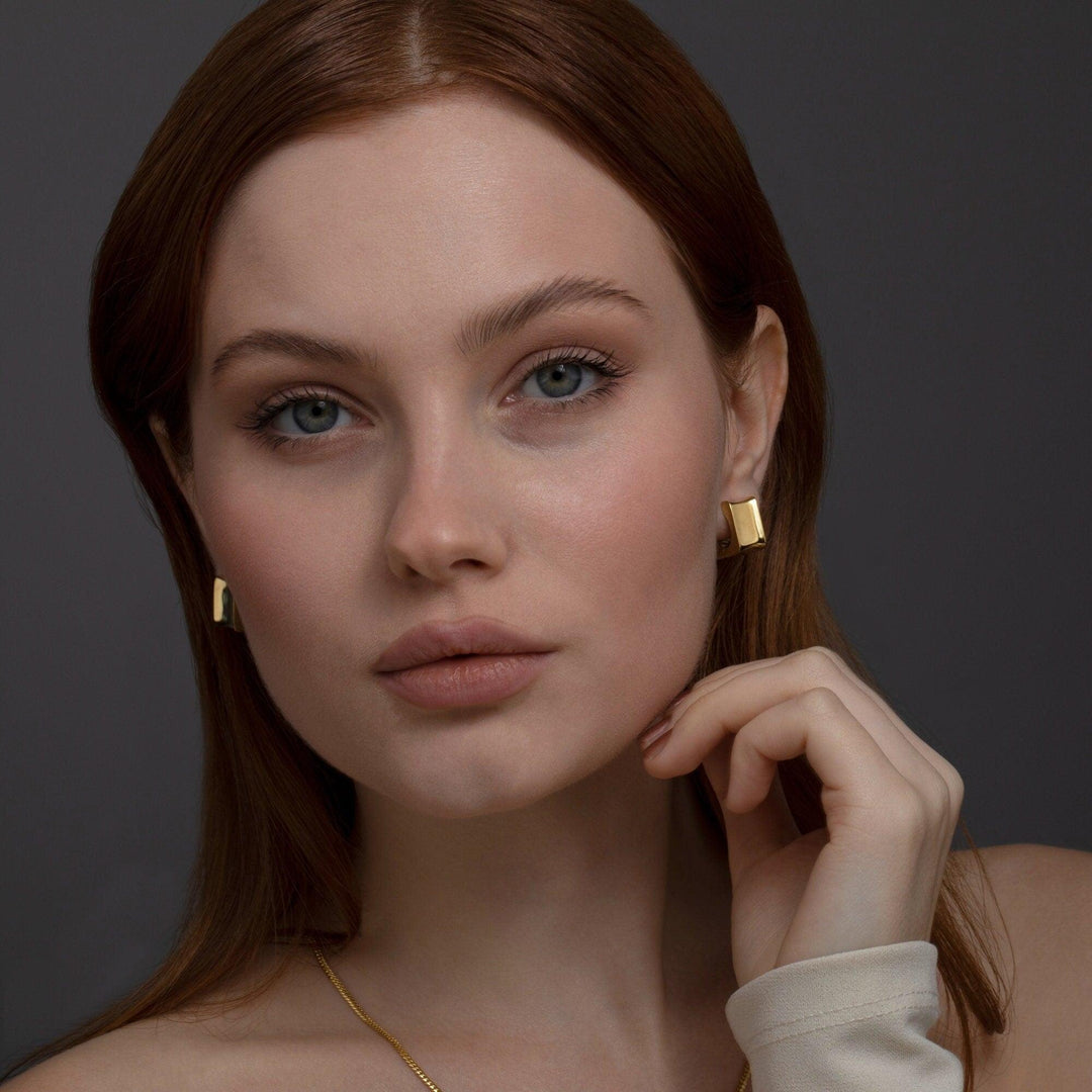 The Chunky Square Huggie Hoop Earrings styled in 18K Gold Vermeil — elegant everyday jewelry. Hypoallergenic for sensitive.