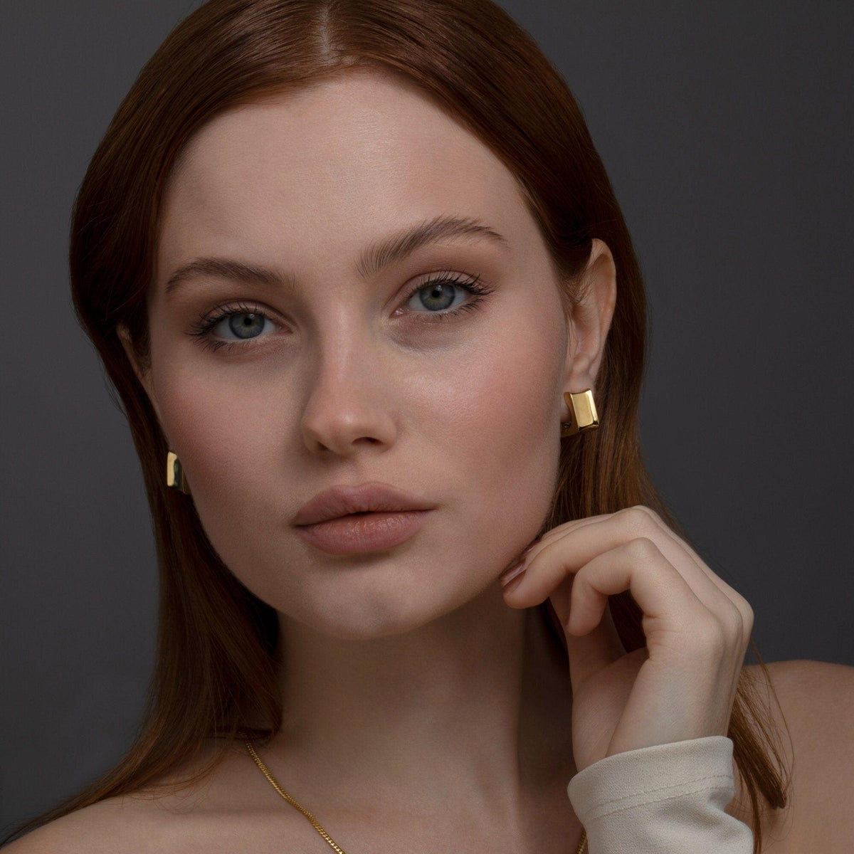 The Chunky Square Huggie Hoop Earrings styled in 18K Gold Vermeil — elegant everyday jewelry. Hypoallergenic for sensitive.