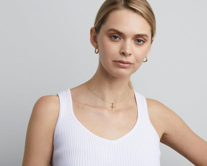 The Small Cross Necklace for Women styled in 18K Gold Vermeil — elegant everyday jewelry. Hypoallergenic, no green marks.