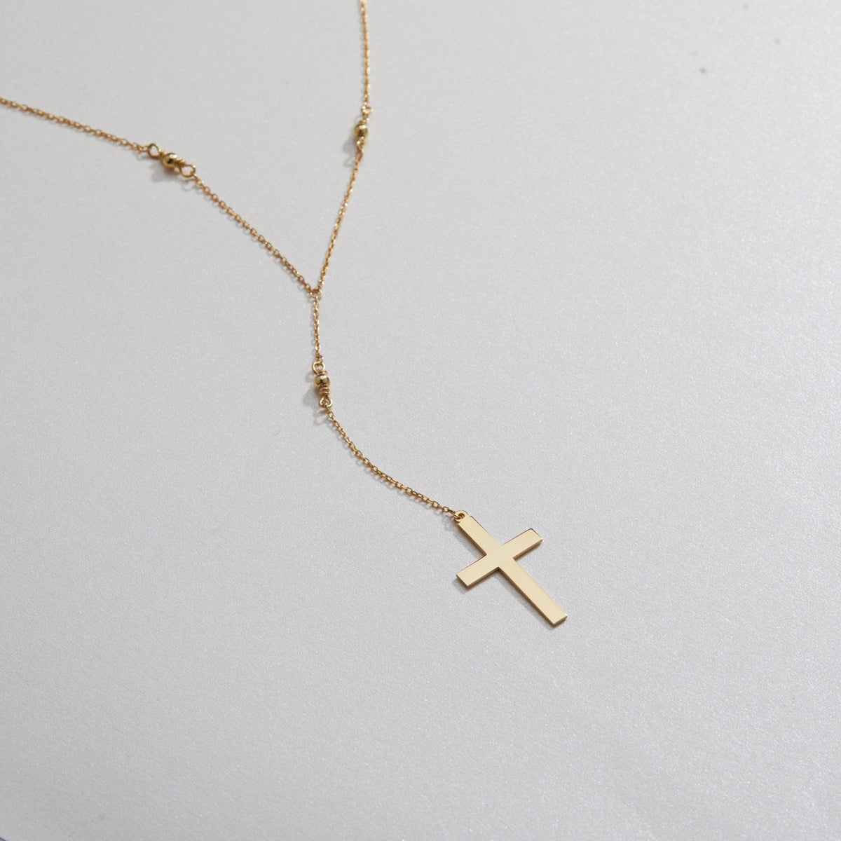 Macro detail of the Cross Pendant Necklace showcasing craftsmanship in 18K Gold Vermeil. Tarnish-resistant, handmade.