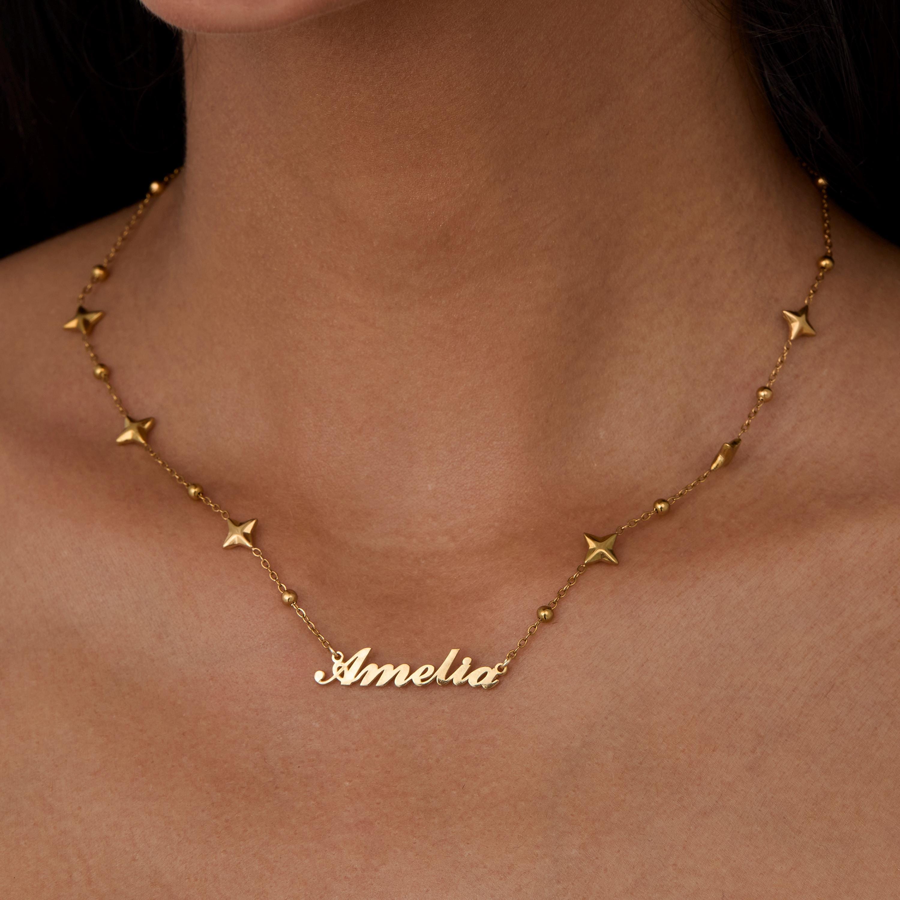 Custom Name Necklace with Star Charms styled with complementary pieces in Gold-Plated Steel. Hypoallergenic, no green.