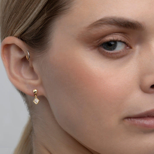 Close detail of the CZ Diamond Solitaire Drop Earrings in 18K Gold Vermeil with CZ Diamond. Tarnish-resistant, premium.