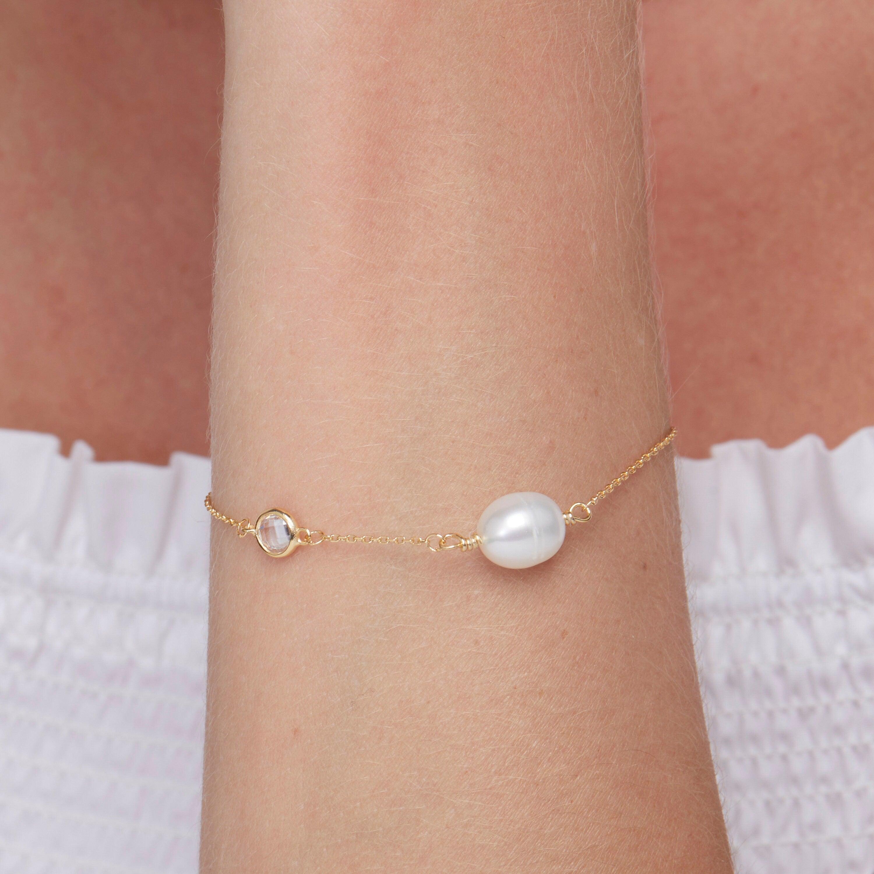 Macro detail of the Dainty Freshwater Pearl Charm Bracelet: Freshwater Pearl set in 18K Gold Vermeil. Tarnish-resistant.