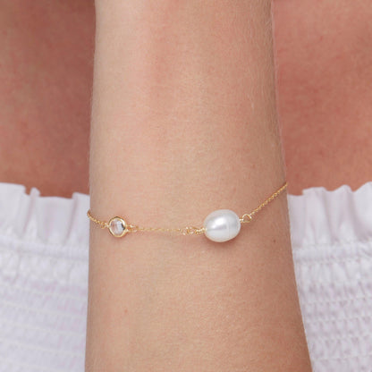 Macro detail of the Dainty Freshwater Pearl Charm Bracelet: Freshwater Pearl set in 18K Gold Vermeil. Tarnish-resistant.