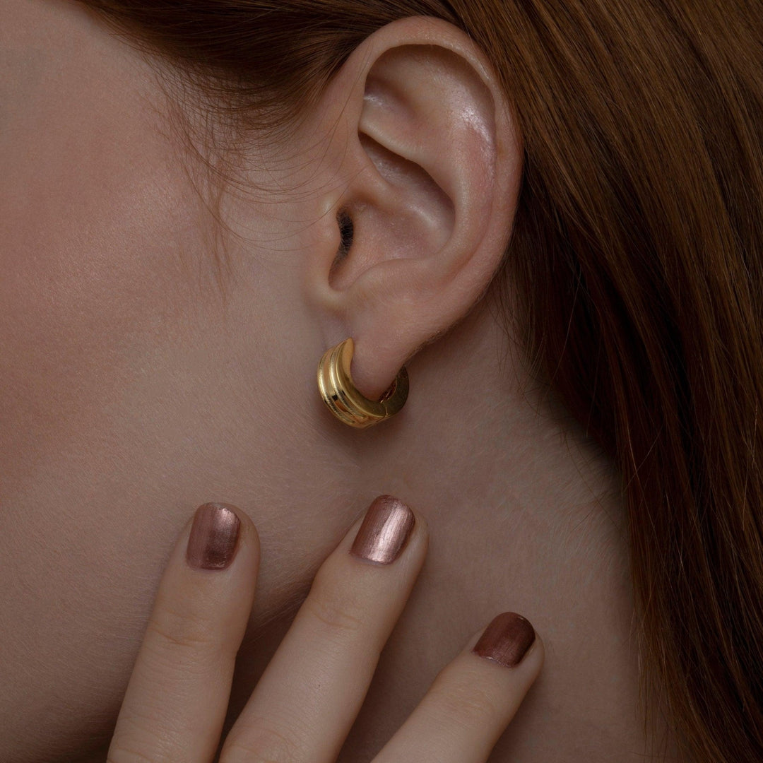 Close detail of the Dainty Huggie Hoop Earrings in 18K Gold Vermeil. Tarnish-resistant, premium handmade jewelry.