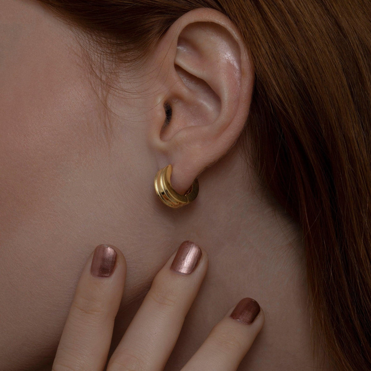 Close detail of the Dainty Huggie Hoop Earrings in 18K Gold Vermeil. Tarnish-resistant, premium handmade jewelry.