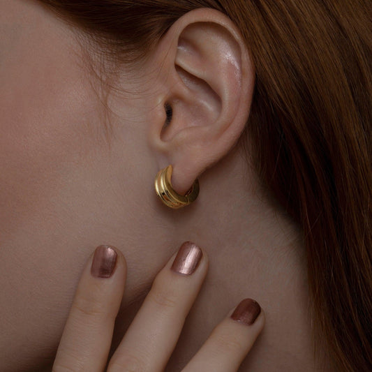 Close detail of the Dainty Huggie Hoop Earrings in 18K Gold Vermeil. Tarnish-resistant, premium handmade jewelry.