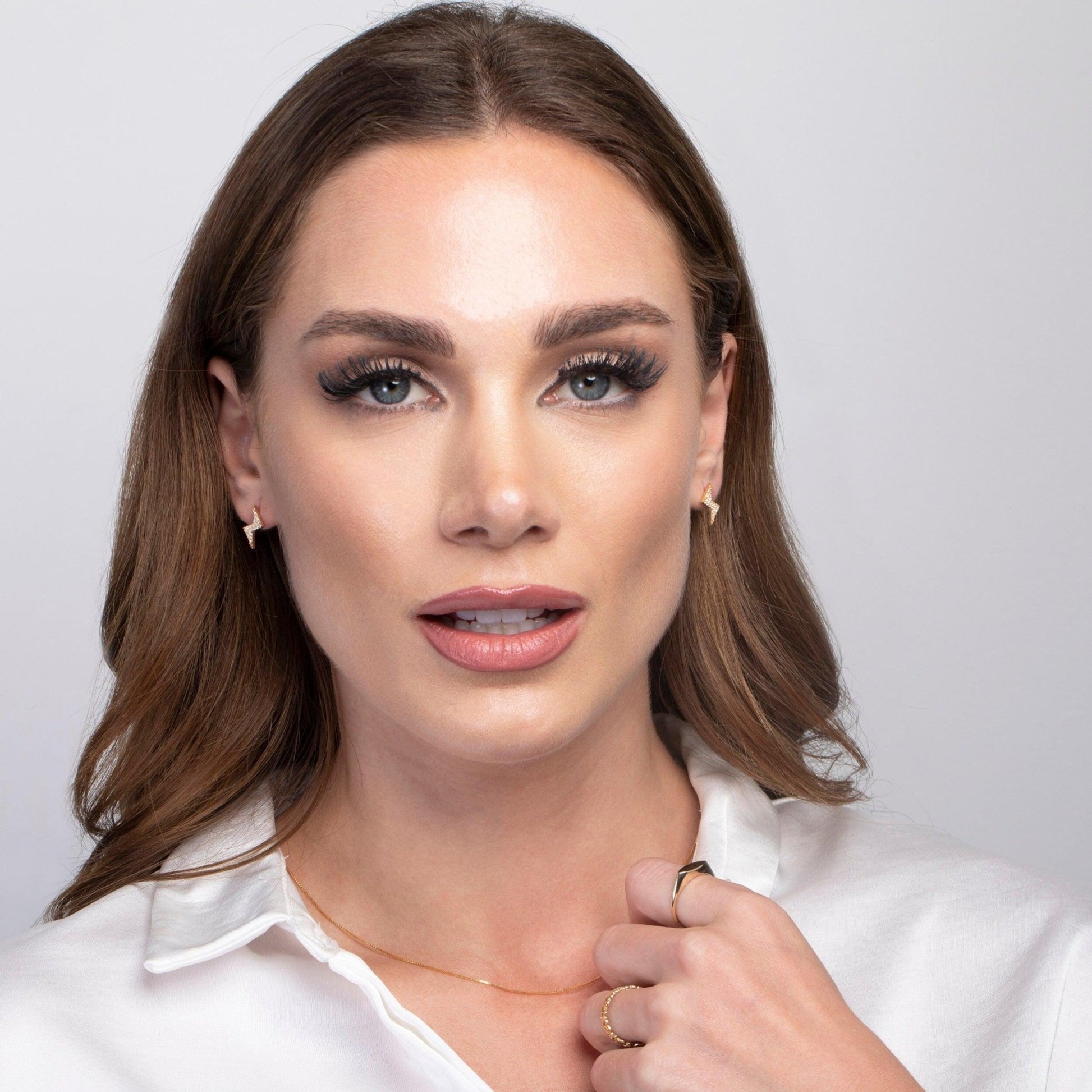 The Dainty Lightning Bolt Stud Earrings styled in 18K Gold Vermeil — elegant everyday jewelry. Hypoallergenic for sensitive.