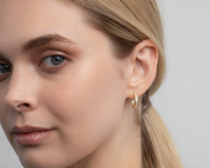 The Dainty Pavé Hoop Earrings styled in 18K Gold Vermeil — elegant everyday jewelry. Hypoallergenic for sensitive ears.