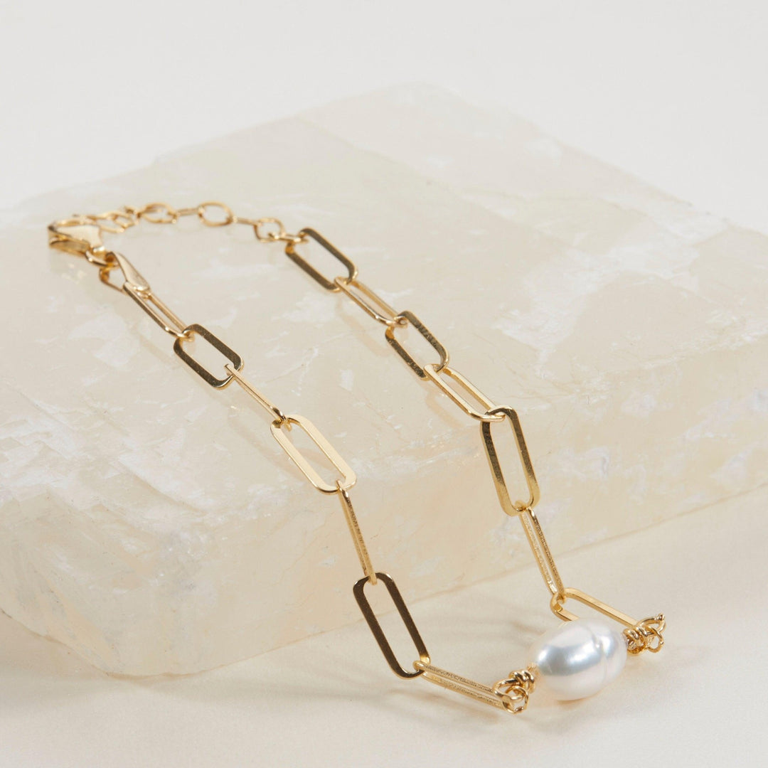 Macro detail of the Dainty Pearl Paperclip Chain Bracelet: Freshwater Pearl set in 18K Gold Vermeil. Tarnish-resistant.